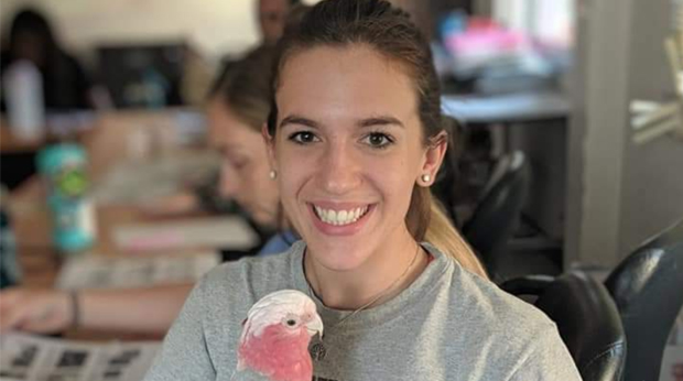 La Roche University student Isabelle Orange holding a bird during a pre-veterinary semester abroad in Thailand.